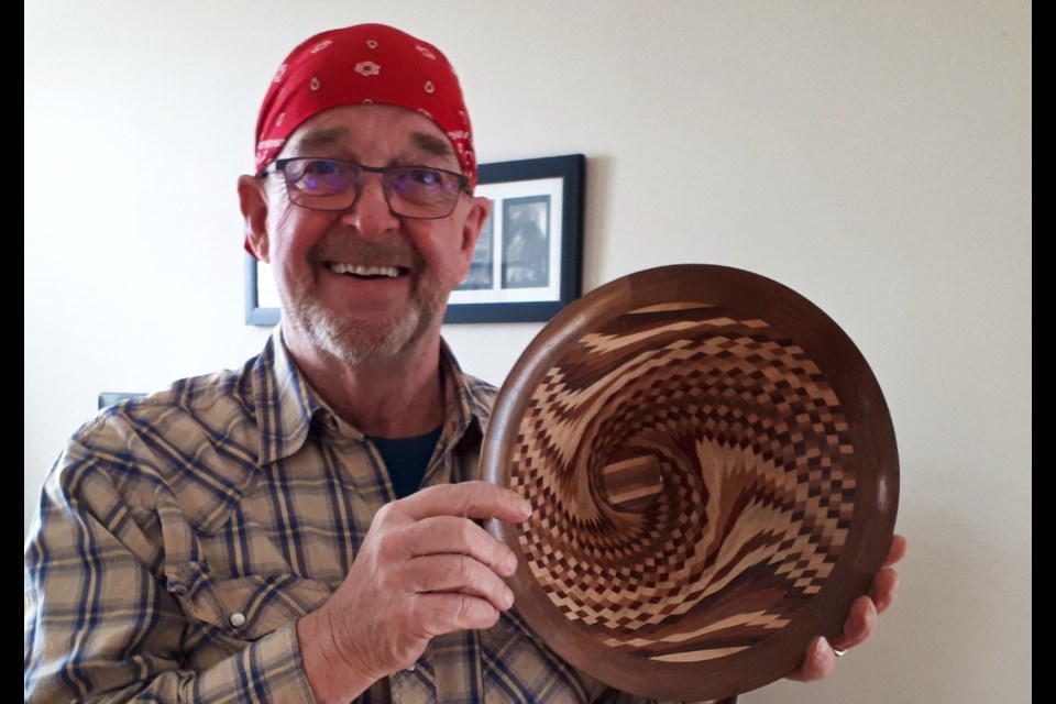 Dirk Hoogendoorn, a wood turning hobbyist, holding one of the bowls he has created. 