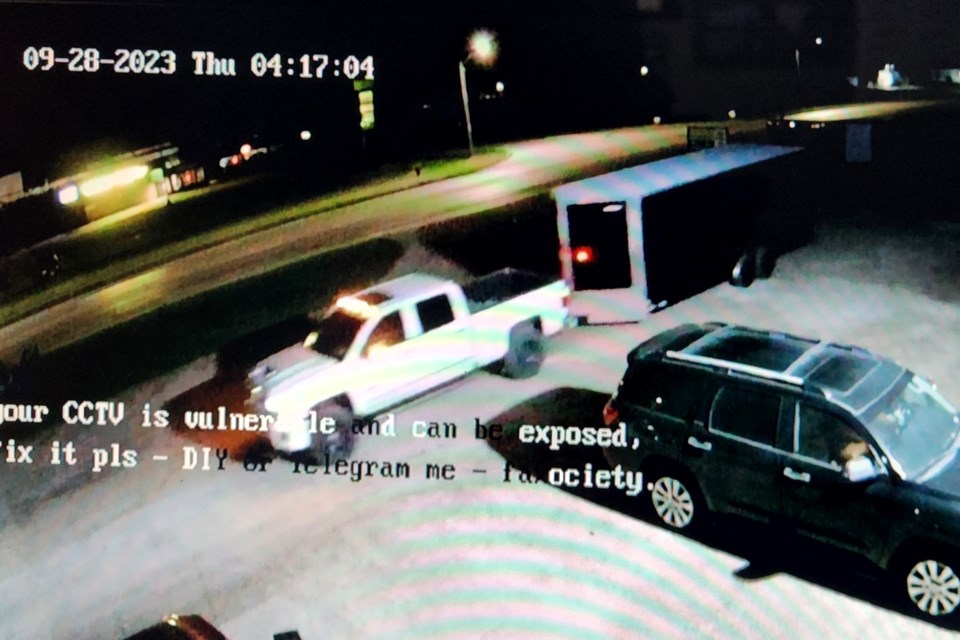 Surveillance camera image of the suspect truck, a 2017-2019 Chev Silverado HD pickup, pulling a stolen trailer