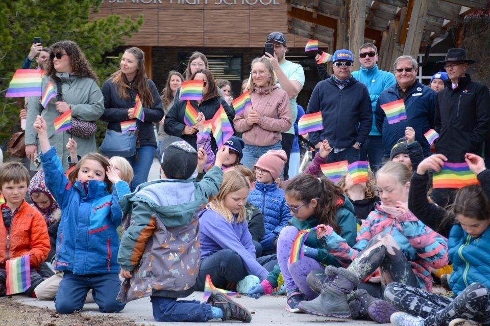 Students wave their Pride flags during a flag raising ceremony at the Jasper Junior/Senior High School on April 12. This ceremony kicked off the 15th annual Jasper Pride and Ski Festival. | Peter Shokeir / Jasper Fitzhugh