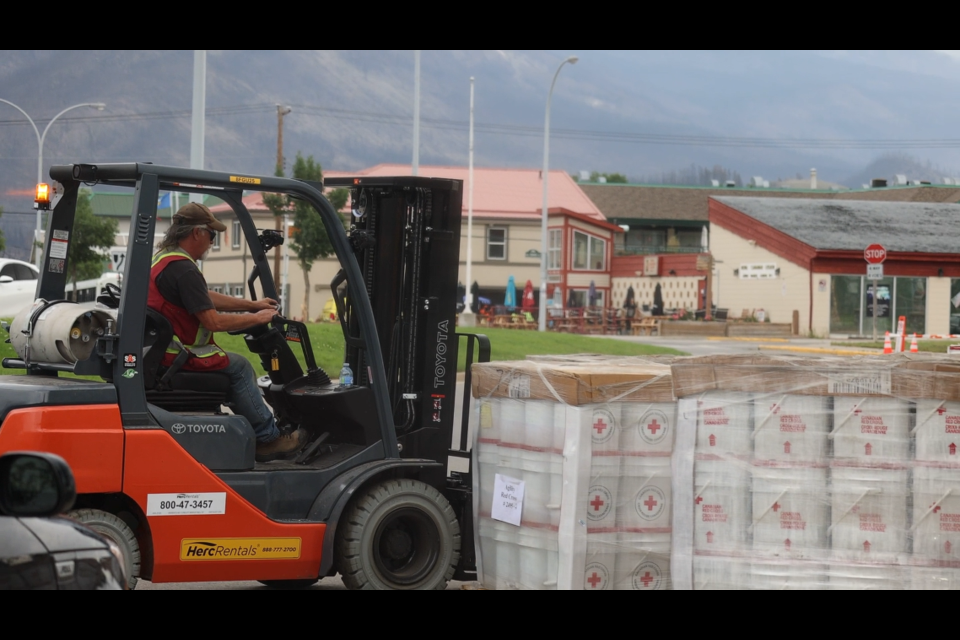 Red Cross personnel set up the Re-entry Support Centre in Jasper on Thursday, Aug. 14, 2024. The centre had rows of clean-up kits available at no cost to all residents.