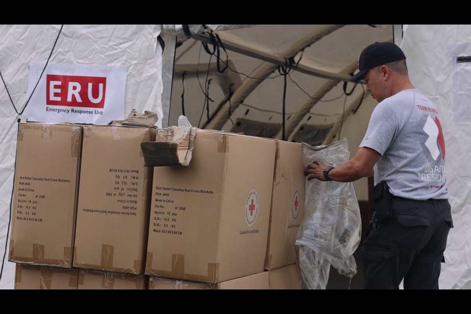 Red Cross personnel set up the Re-entry Support Centre in Jasper on Thursday, Aug. 14, 2024. The centre had rows of clean-up kits available at no cost to all residents.