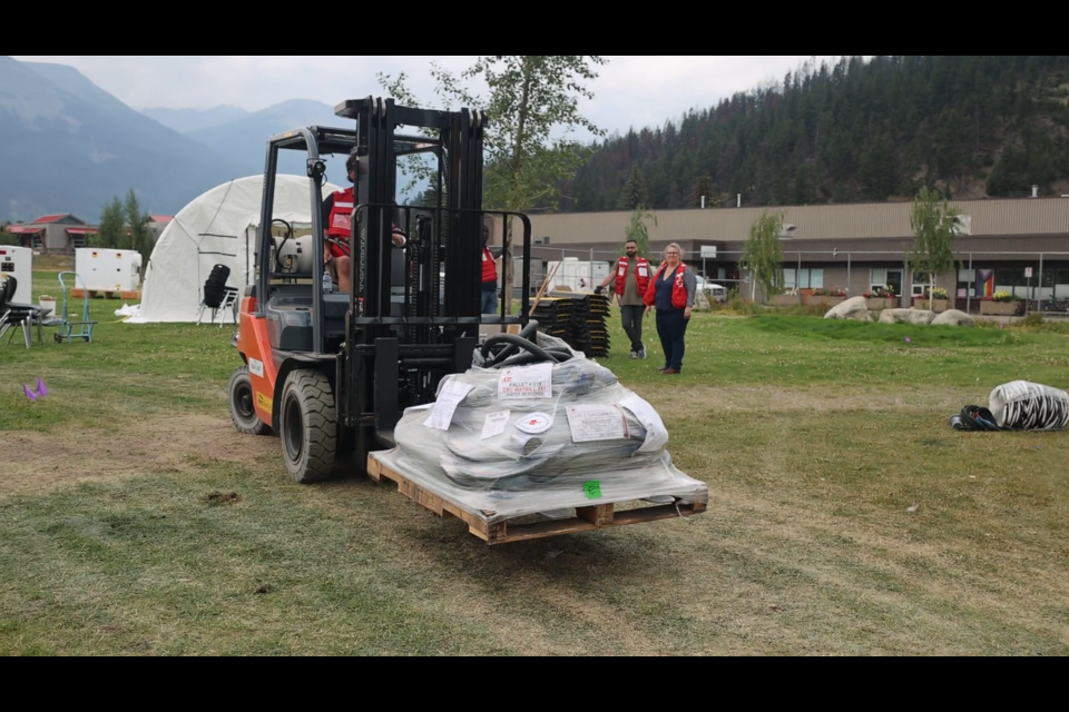 Red Cross personnel set up the Re-entry Support Centre in Jasper on Thursday, Aug. 14, 2024. The centre had rows of clean-up kits available at no cost to all residents.