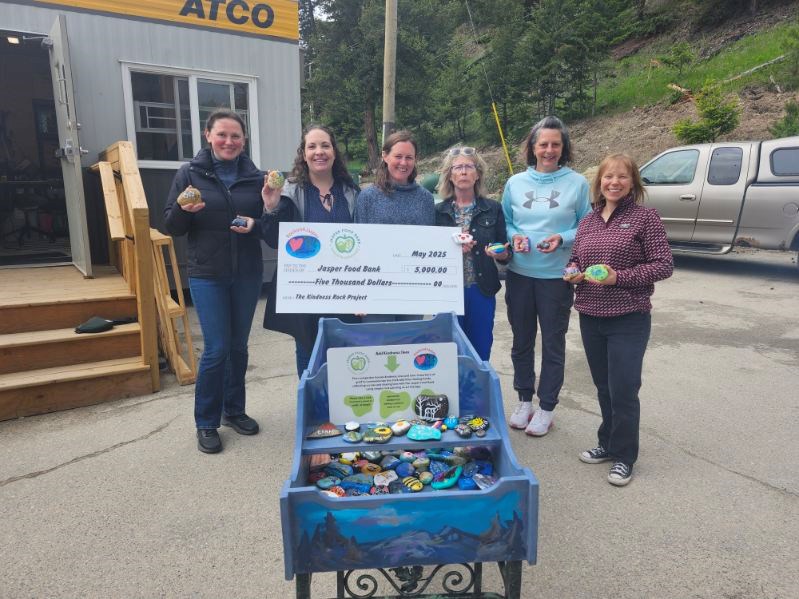 The Jasper Food Bank accepts a cheque for $5,000 from Rock on 4 Jasper during the grand opening of the food bank's new location on Saturday, May 31, 2025.
