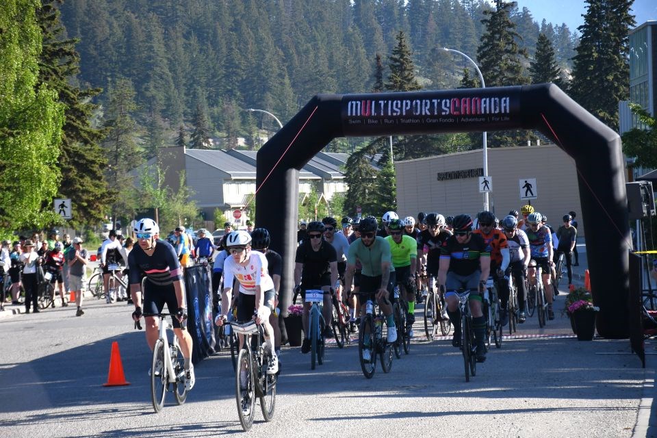 Jacob Playfair (in white) takes the lead as cyclists begin the Grand Fondo along Bonhomme Drive in Jasper, Alta. on Saturday, June 7, 2025. Playfair came in first.