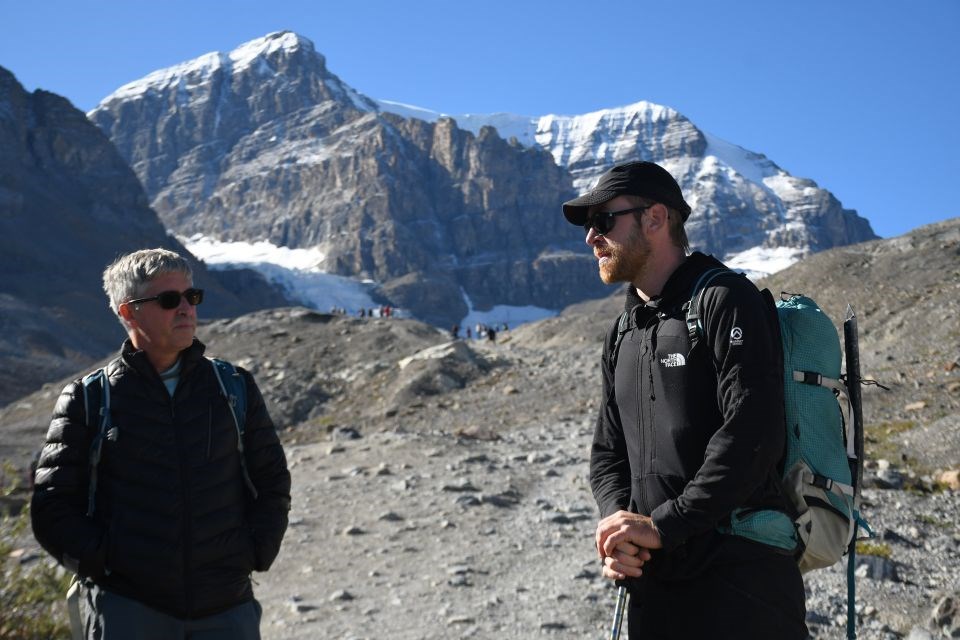 Volunteer guide Maarten van Haeren with Brian Menounos, a geography professor at the University of Northern British Columbia, near the toe of the Athabasca Glacier in Jasper National Park on Thursday, Aug. 21, 2025.