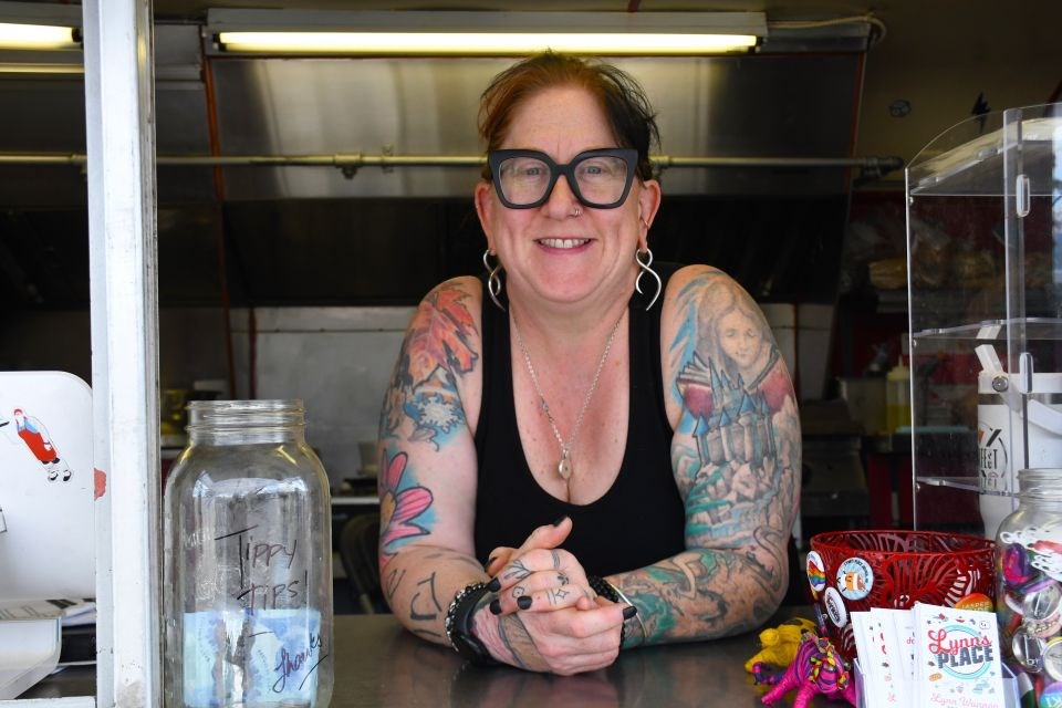 Lynn Wannop stands inside her trailer at the pop-up village along Connaught Drive in Jasper, Alta. on Wednesday, June 18, 2025.