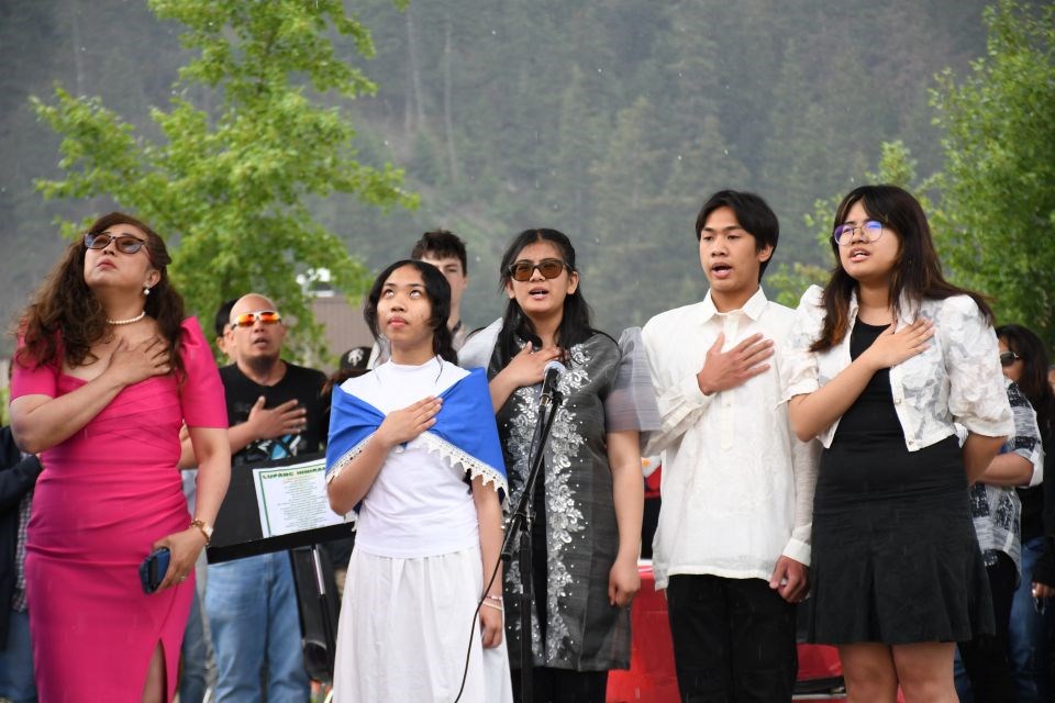 The Filipino community sings the Philippine National Anthem during the second Filipino Flag Raising Ceremony at Commemoration Park in Jasper, Alta. on Thursday, June 12, 2025.