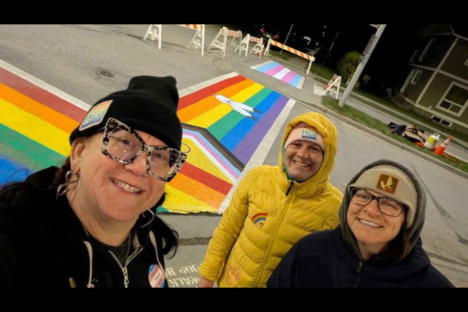 From the left: Jasper Pride secretary Lynn Wannop with co-chairs Mollie Lalonde Lynch and Wendy Hall in front of the Pride crosswalks in Jasper, Alta.