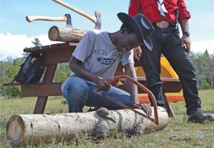 Rwema Yannick learns how to cut wood at Marmont Meadows Sept. 7.