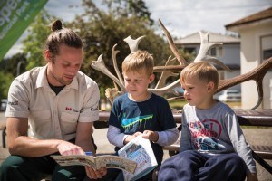 Two young boys holding explorers booklets with interp angle 2