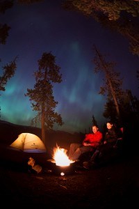 Couple Camping Below Northern Lights