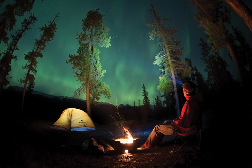 Man watches Northern Lights
