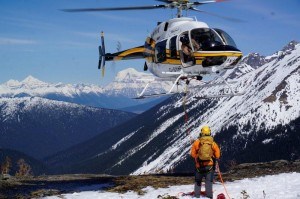 Aaron Harris hovers above Rupert Wedgwood visitor safety manager for Jasper National Park during his long line certification test in Valemount, B.C.  Photo - Parks Canada, Max Darrah
