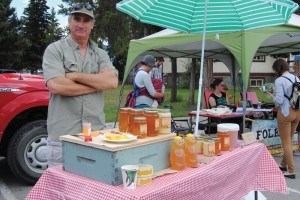 Garry Neufeld, the owner of Wildflower Waggle Dance Honey one of several venders at the farmers market, June 24. Photo - P. Clarke. 