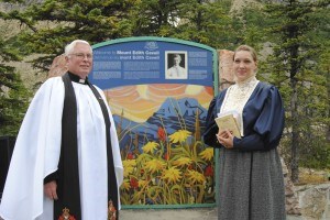 Retired Anglican rector David Prowse and Stephanie Marr as Edith Cavell stand at a monument erected at the base of the mountain, August 2. Photo - P. Clarke.