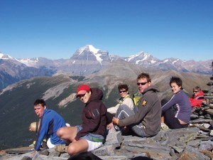 A group of hikers take a rest at the summit of Mount Terry Fox with Mount Robson in the background. Photo provided.
