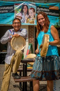 Two intepreters pose with drums outside the old firehall for an aboriginal program
