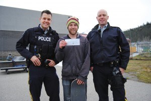 Const. Patrick Valle (left) and Const. Mat Belliveau (right) presented a $1,000 cheque to Darrell Savage, president of the Jasper Skaepark Community. Photo - P. Clarke