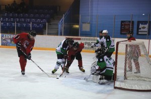 Hunter Zenner picks up a loose puck in the crease. Photo - Yaqing Yang.