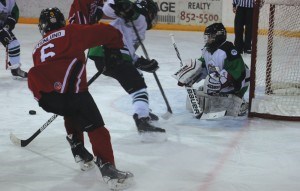Magnus Stenlund sends a puck to the front of the net. Photo - Yaqing Yang.