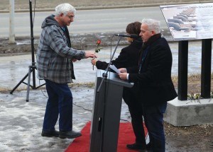 Willie Lischewski takes a rose to place on the monument in honour of one of the victims_Hinton Voice-C.Biggrig photo