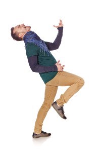Young man playing air guitar in full length