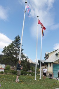  Sara Anne Gibson (left) and OUT Jasper program coordinator Mychol Ormandy were on hand to raise the pride and transgender flag, May 17. Photo - K. Byrne. 