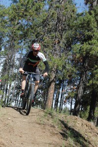 Matt Staneland, chair of the Jasper Cycling Association takes a spin where the future bike park could be located, spending Parks Canada's approval. Photo - K. Byrne. 