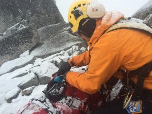 A rescue technician prepares Titchener to be rescued by helicopter. Photo submitted
