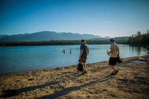 Two men enjoy the beach at Lake Annette. Photo - B. Morin/Parks Canada