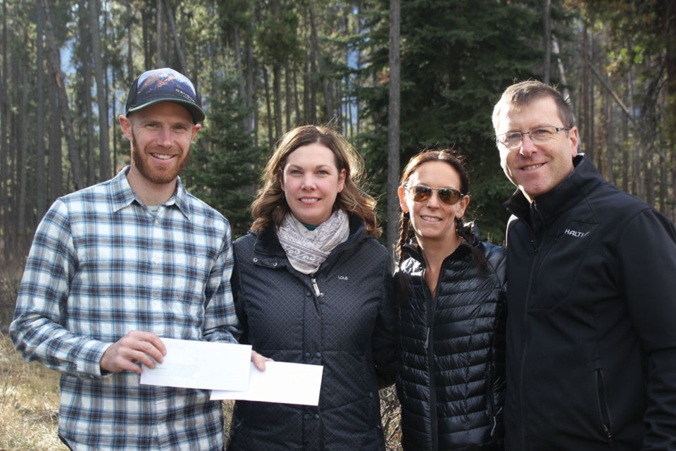 From left to right: Matt Staneland, chair of the Jasper Park Cycling Association, poses with Alana Gulevich, owner of Mount Robson Inn, Kim Stark, owner of Bear’s Paw Bakery and Patrice Fortin, owner of Fiddle River Restaurant. Each business donated an unspecified amount of money for the town’s new bike park. P. Clarke photo.  