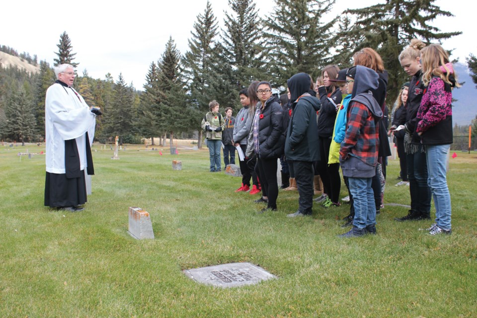 About 40 Grade 8 students from Jasper Junior/Senior High School gathered at the Jasper Cemetery to place poppies at the graves of veterans. Rev. David Prouse led students in a moment of silence after a few excerpts from his prayer book. P. Clarke photo