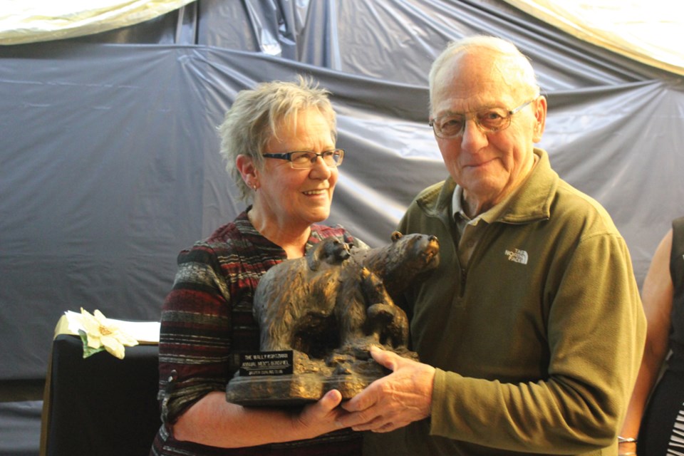 After 27 years Wally Kortzman will retire from his ice-making duties at the Jasper Curling Club at the end of the season. Curling club member, Dorothy Marquis (left), present him with an award Nov. 5. P. Clarke photo. 