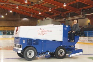 Jasper Arena manager Peter Bridge poses with the arena’s new Zamboni in September 2016. The new machine continues to have problems properly flooding the ice. File photo.