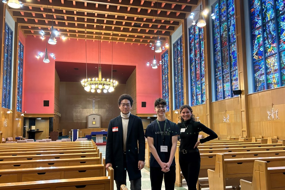 Laureate College students Tommy Lian (left) and Matthew Baslious give Katie DeSilva of Kanalink a tour of the school's chapel during the Business After 5 on Wednesday.