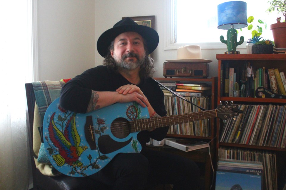 CC Trubiak and his signature acoustic guitar, seen here in his home studio. The Flin Flon musician and country music devotee has began showing his latest project, Honky Tonk Angels, a combination of performance, research and paying homage to seven of his favourite country songstresses.