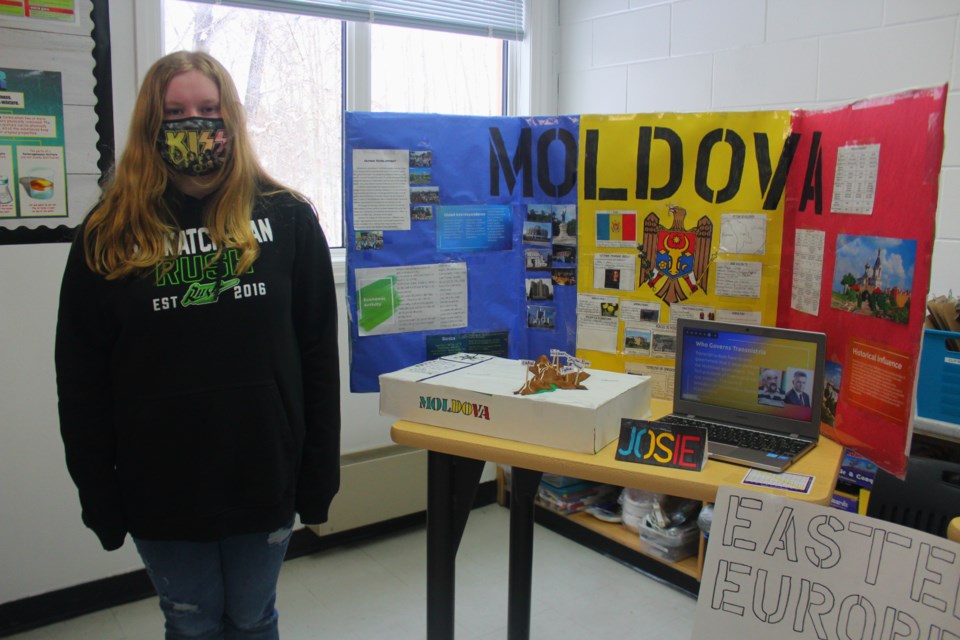 Josie Wiens stands next to her project, which details the small Eastern European nation of Moldova.