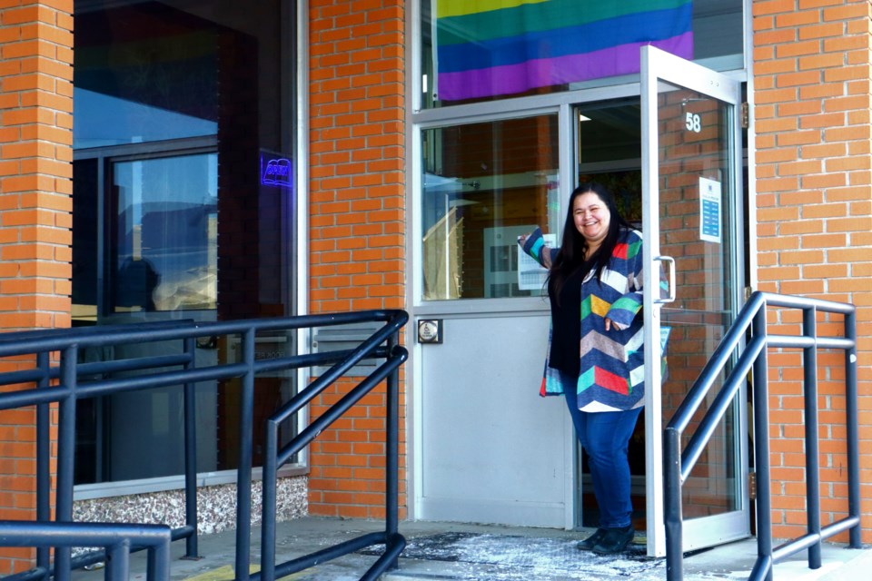Flin Flon Public Library administrator Lisa Slugoski waves people in during the library's reopening day Jan. 4. The library opened back up to the public after two months of repair work on the building.