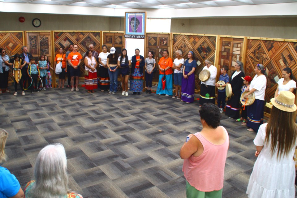 Attendees pay one last visit to the Witness Blanket at City Hall during the closing ceremony for the exhibit July 22.