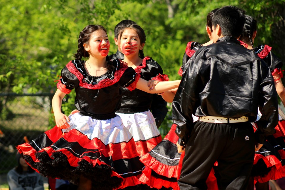 The Andrew Ballantyne Memorial Square Dancers perform. The group's four girl dancers performed while wearing the red handprint - a symbol of solidarity with missing and murdered Indigenous women - on their faces.