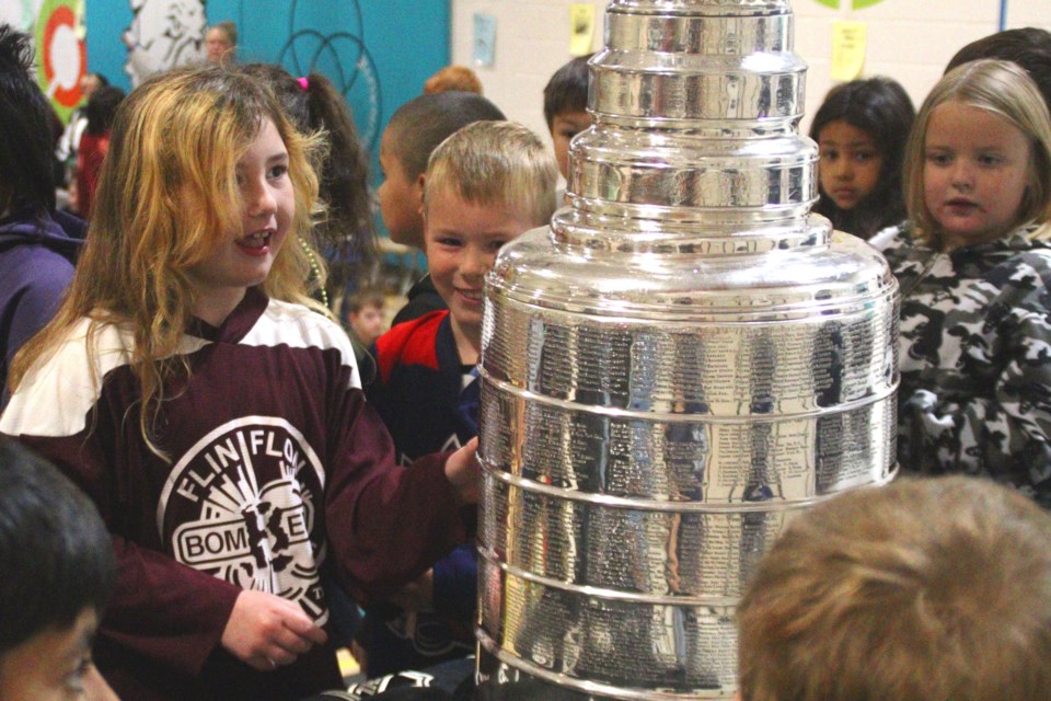 Sawyer Phillips gets a chance to touch the Stanley Cup during the trophy's visit to Flin Flon Oct. 17. Phillips and other kids in Flin Flon and Creighton got a chance to see it for themselves during Vegas Golden Knights scout Erin Ginnell's trip home with the Cup.