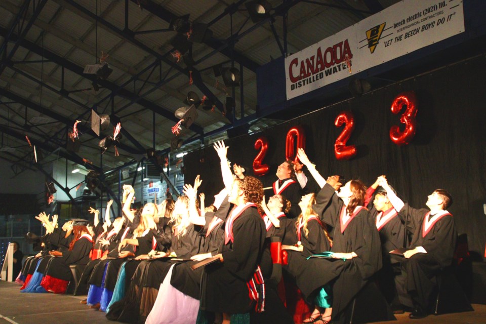 Hapnot Collegiate's Class of 2023 tosses their caps in celebration during the graduation ceremony.