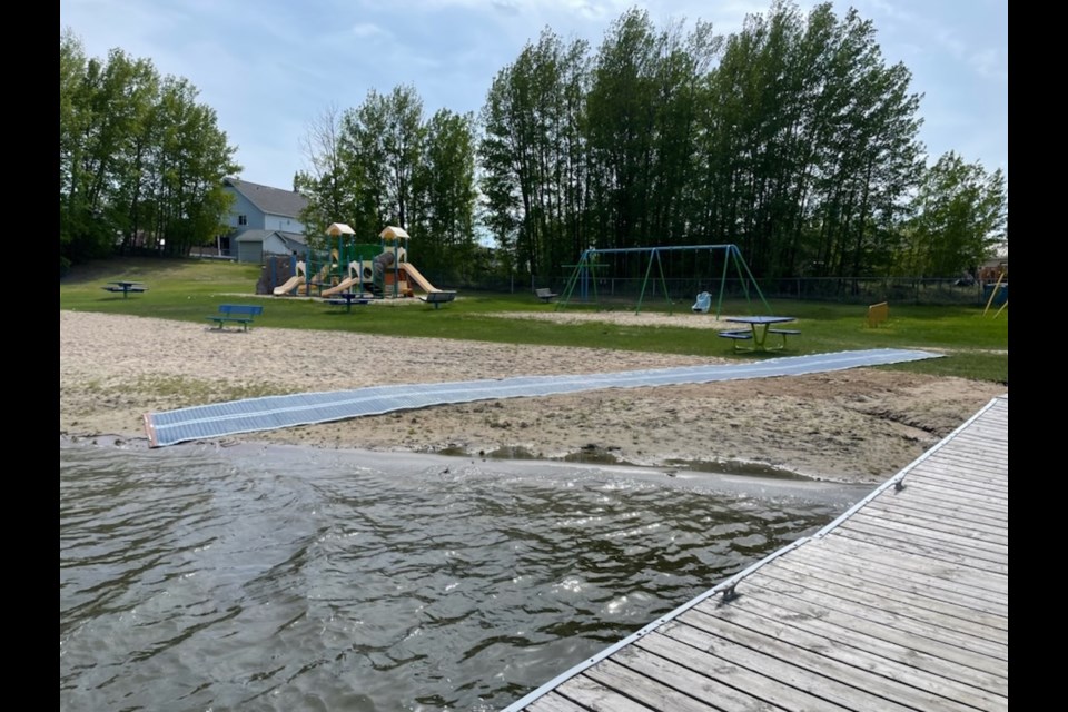 A new Mobi-Mat and accessible picnic table sit at Channing Beach after being installed earlier this week. The new mat and table, along with a new swing, are part of accessibility upgrades that have recently been made for the beach.
