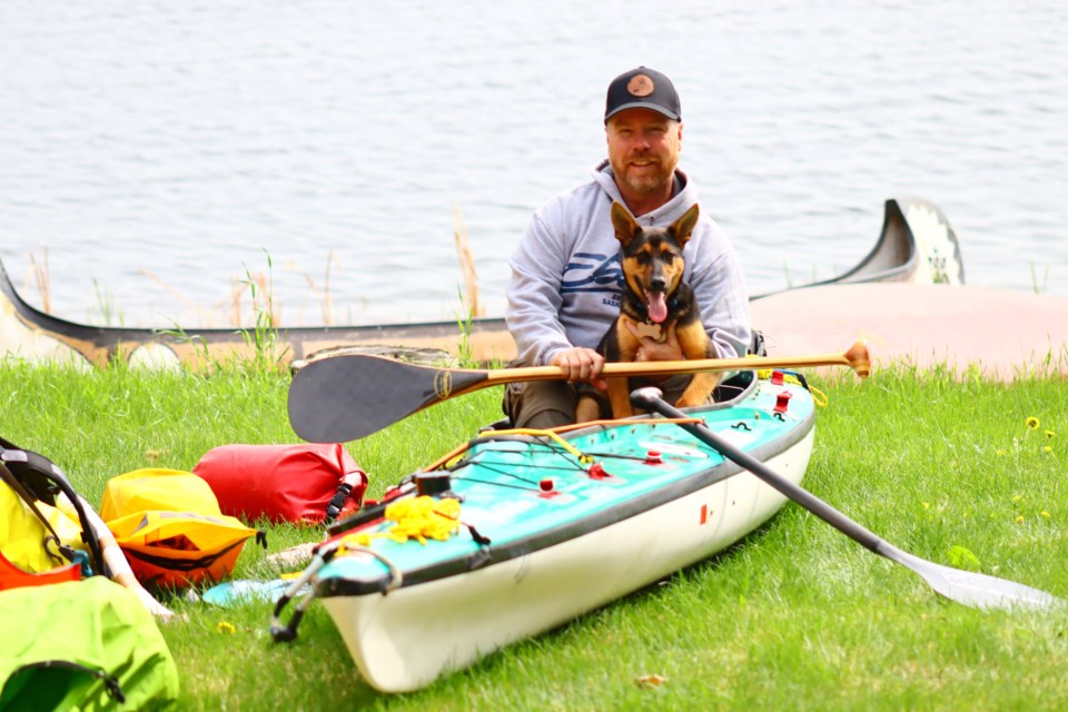Dave Koop, seen here with puppy Taiga, his canoe and some of his equipment, is embarking on a one-man canoe trip that will take him from Schist Lake to the Arctic Ocean.