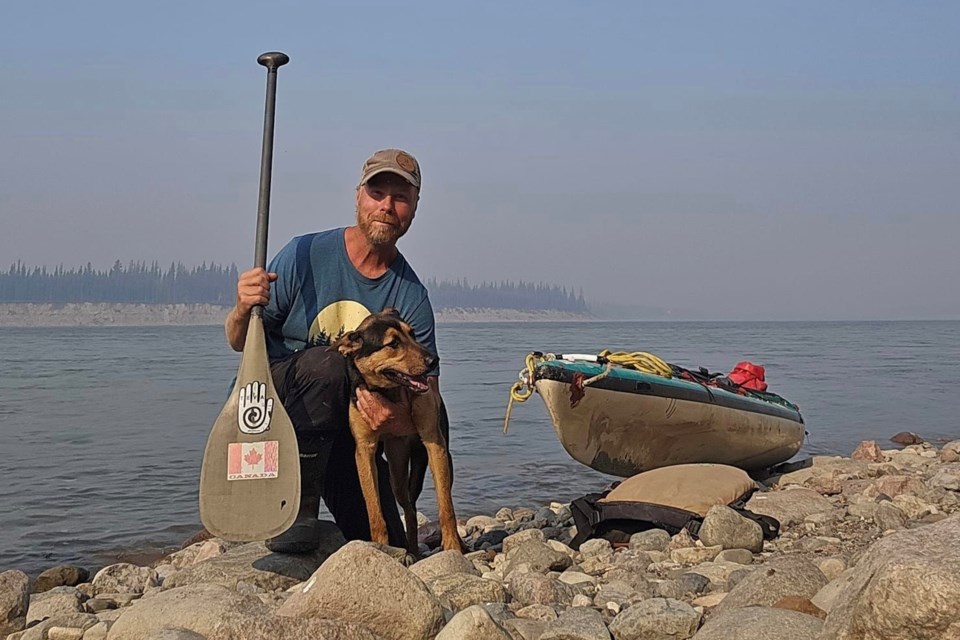 Dave Koop and his travel partner Taiga, seen here with their canoe on the shores of the Mackenzie River in the Northwest Territories. Koop has returned home after a months-long solo canoe voyage that took him from Schist Lake to the territories.
