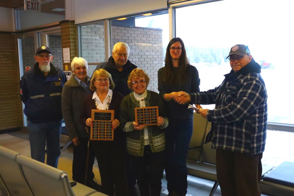 Members of CASARA Flin Flon formally hand over the group’s trailer to the Flin Flon
Airport while showing two plaques commemorating the group that will be mounted
inside the terminal. From left are Stewart Graham, Ruth Angell, Doreen Murphy, Gene
Kostuchuk, Geri Kostuchuk, airport manager Jeni East and Gerry Angell.