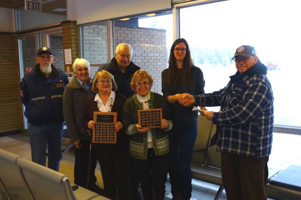 Members of CASARA Flin Flon formally hand over the group’s trailer to the Flin Flon
Airport while showing two plaques commemorating the group that will be mounted
inside the terminal. From left are Stewart Graham, Ruth Angell, Doreen Murphy, Gene
Kostuchuk, Geri Kostuchuk, airport manager Jeni East and Gerry Angell.