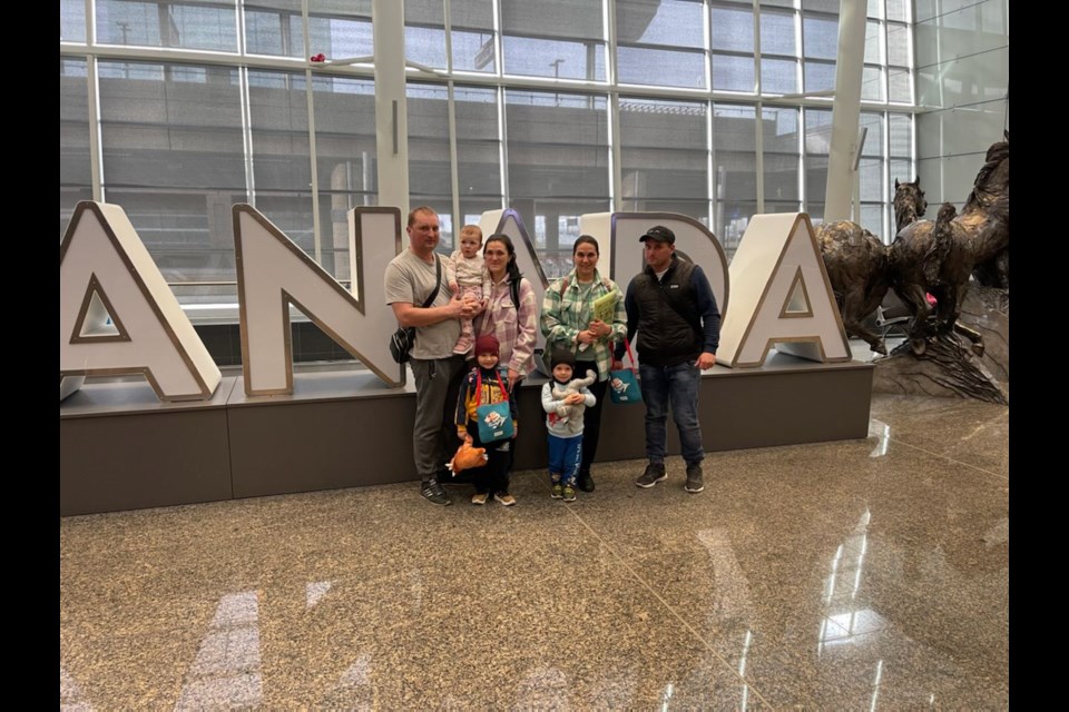 Family members of former Flin Flonner Peter Premachuk pose for photos after arriving in Canada from war-torn Ukraine. The seven family members are now living with Premachuk in Alberta. 