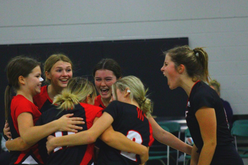 JV Hapnot Kweens players celebrate winning a big point in a win over MBCI during a tournament at Creighton Community School Oct. 29.