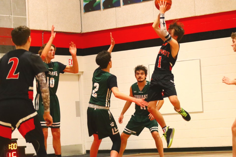 Hapnot's Hunter Hynes pulls up for a mid-range shot attempt over a crowd of Kodiaks defenders during the two teams' Dec. 21 matchup at Hapnot Collegiate.